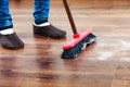 Cleaning woman sweeping wooden floor