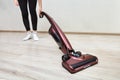 Cleaning woman vacuums with handheld vacuum cleaner with lights