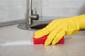 Deep Cleaning service. woman yellow gloves hands cleaning kitchen table with red sponge. Surface sanitizing. Home cleaning and Royalty Free Stock Photo