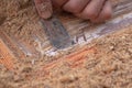 Cleaning a wooden old door from paint with an spatula close-up. restoration