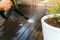 Cleaning wooden terrace planks with high pressure washer Royalty Free Stock Photo