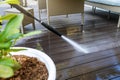 Cleaning wooden terrace planks with high pressure washer Royalty Free Stock Photo