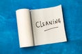 Cleaning word write on a paper kitchen napkin roll on a blue background