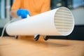 Cleaning worker uses an ozone generator while cleaning coworking space Royalty Free Stock Photo