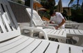 A cleaning worker wearing protective mask clean a hammock in a hotel in Mallorcal wide