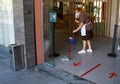 A cleaning worker wearing protective mask scrub the floor of a hotel entrance wider