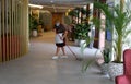 A cleaning worker wearing protective mask scrub the floor of a hotel wider