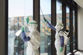 Cleaning Workers Disinfecting Windows in Office Royalty Free Stock Photo