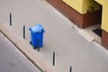 Blue trash can on street pavement Royalty Free Stock Photo