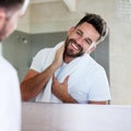 Cleanliness is next to godliness. a handsome young man going through is morning routine in the bathroom.