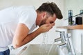 Cleanliness is next to godliness. a handsome young man going through is morning routine in the bathroom.