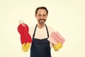 Cleanness is in his hands. Mature household helper. Mature household worker holding laundry detergent in rubber gloves