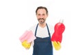 Cleanness is in his hands. Mature household helper. Mature household worker holding laundry detergent in rubber gloves Royalty Free Stock Photo