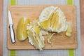 Purified pomelo lying on a wooden board Royalty Free Stock Photo