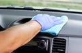 Cleansing car interior. Male hand in protective glove disinfecting vihicle inside