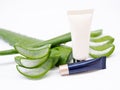 Cleansing foam, cream tube with aloe vera, leaf slices with gel. Royalty Free Stock Photo