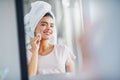 Cleansing her skin to reveal her natural beauty. a beautiful young woman cleaning her face with cotton wool in the Royalty Free Stock Photo