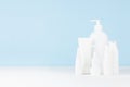 Cleansing and skin care cosmetics bottles mockup in elegant soft light white and blue bathroom interior on table, copy space. Royalty Free Stock Photo