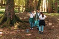 Cleanup volunteers collecting trash in the forest