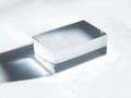 Clear acrylic block casting shadow on white background Royalty Free Stock Photo