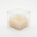 Clear acrylic cube with white shredded paper inside, isolated on white background isolated on white background Royalty Free Stock Photo