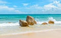 Clear azure sea crashing on rocks