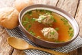 Clear beef broth with liver dumplings close up in a dish. horizontal