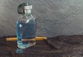 Clear blue aftershave bottle with old razor on wet stone Royalty Free Stock Photo