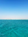 Clear blue ocean with distant sandy shore Royalty Free Stock Photo
