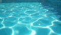 Clear blue pool water surface with bright sun reflections creating calming light patterns. Clean aquatic background for summer Royalty Free Stock Photo