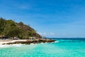 Clear blue sea, blue sky and white sand with little pavilion