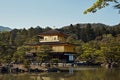 Clear blue skies at Kinkaku-Ji temple surrounded by forest Royalty Free Stock Photo