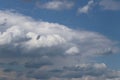 Clear blue sky with cumulus and cirrus clouds. Sunny weather with dark clouds. Joyful mood. High pressure. Clean air ecology. Wate Royalty Free Stock Photo