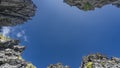 Clear blue sky framed by the rocks with sharp peaks. Royalty Free Stock Photo