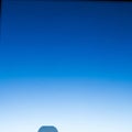 Clear blue sky with a gradient transitioning from deep blue at the top to lighter blue towards the Royalty Free Stock Photo