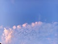 A clear blue sky meets soft, fluffy white clouds at the horizon. Peaceful and vast Royalty Free Stock Photo