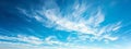 Clear blue sky with soft, white clouds creating a serene skyscape background banner Royalty Free Stock Photo