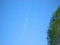 Clear blue sky with two airplanes and parallel contrail line. High sky background with light fluffy trail line from single