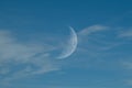 Clear Blue Sky with Whispy Faint Clouds and Faint Half Moon Royalty Free Stock Photo