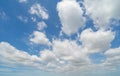 Clear blue sky with white fluffy clouds at noon. Day time. Abstract nature landscape background Royalty Free Stock Photo