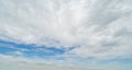 Clear blue sky with white fluffy clouds at noon. Day time. Abstract nature landscape background Royalty Free Stock Photo