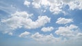 Clear blue sky with white fluffy clouds at noon. Day time. Abstract nature landscape background Royalty Free Stock Photo