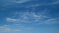 Clear blue sky with white wispy smoke cirrus clouds. Blue sky background with tiny cirrus clouds. Timelapse. Royalty Free Stock Photo