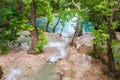 Clear, blue water flow in tropical forest. Royalty Free Stock Photo