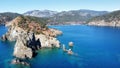 the clear blue water is next to rocks and trees, as seen from a cliff Royalty Free Stock Photo