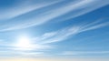 Bright Sun Shining Through Wispy Clouds in a Clear Blue Sky Royalty Free Stock Photo