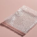 Clear bubble wrap on a pink background, showcasing its transparent texture and round, Royalty Free Stock Photo