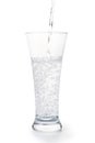 Carbonated water pours into the glass isolated with clipping pat Royalty Free Stock Photo