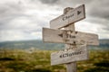 Clear the clutter text engraved on old wooden signpost outdoors in nature