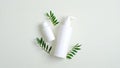 Clear cosmetic bottle containers and green leaves. Minimalist cosmetic product mockups. Natural hand care cream and lotion Royalty Free Stock Photo